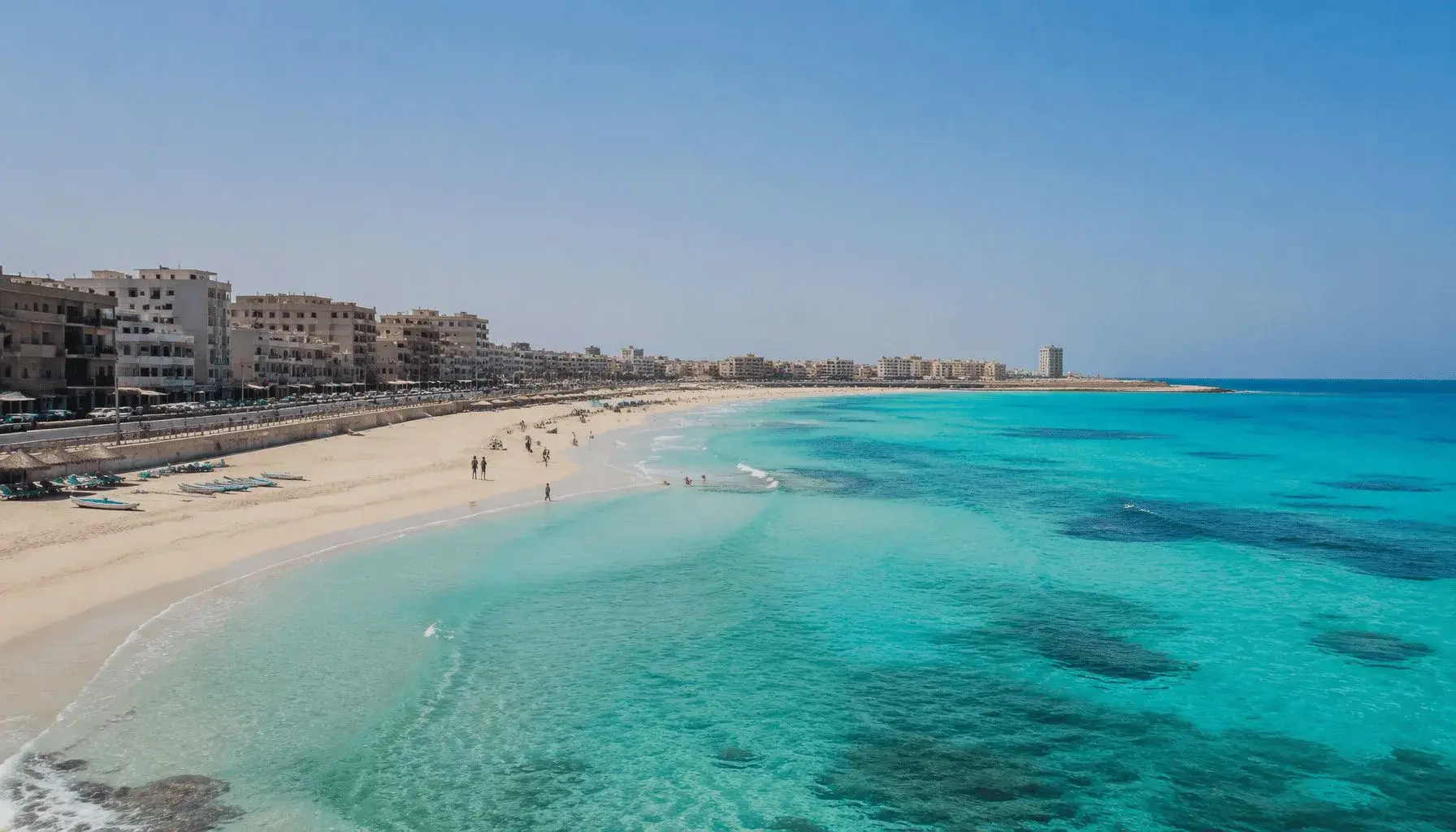 Panorama der Küste von Marsa Matruh in Ägypten mit Corniche, Sandstrand und türkisfarbenem Wasser